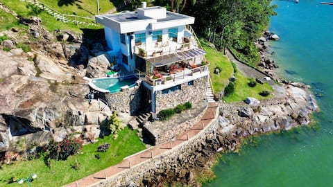 Seafront retreat with swimming pool and private beach.