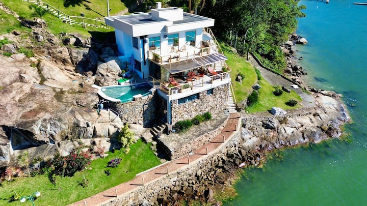 Seafront retreat with swimming pool and private beach.