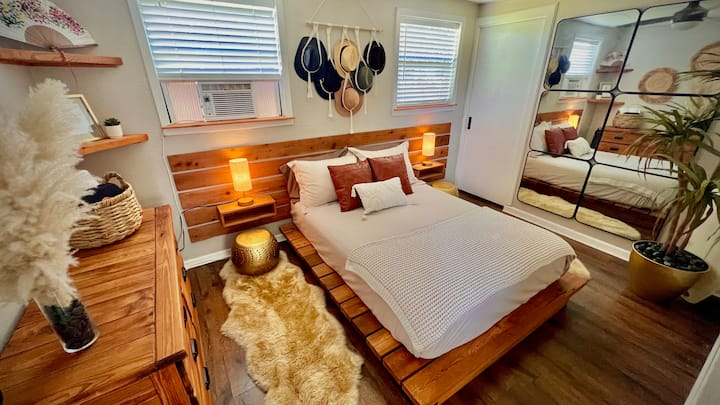 A peaceful bedroom with soft textures, warm lighting, and plenty of storage for a relaxing stay.