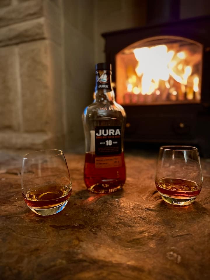 Living room with stone fireplace and cosy seating — perfect for evenings in