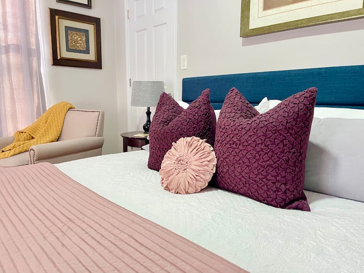 Guests enjoy the spacious KING bedroom with room for luggage, a large closet, laundry basket, comfy chair by the window in front of the smart TV. Always available are extra blankets and pillows for guest comfort.