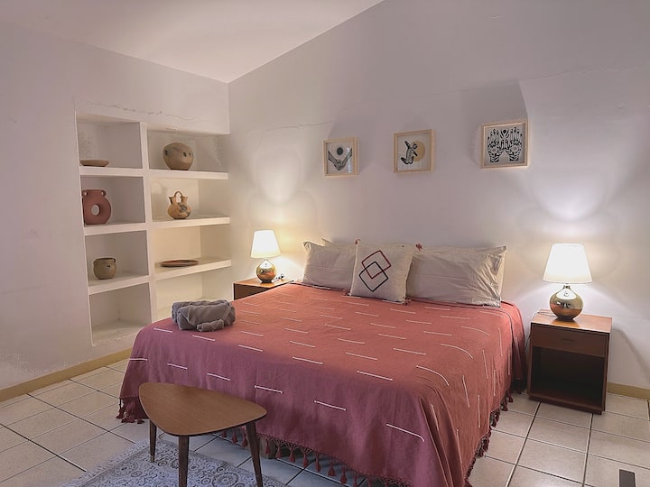 Spacious bedroom with a king-sized bed and plenty of natural light.