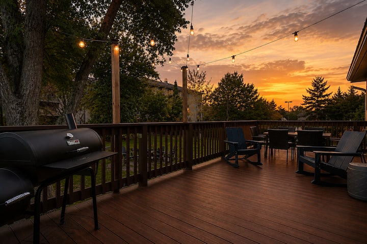 The deck at sunset with the charcoal grill and string lights