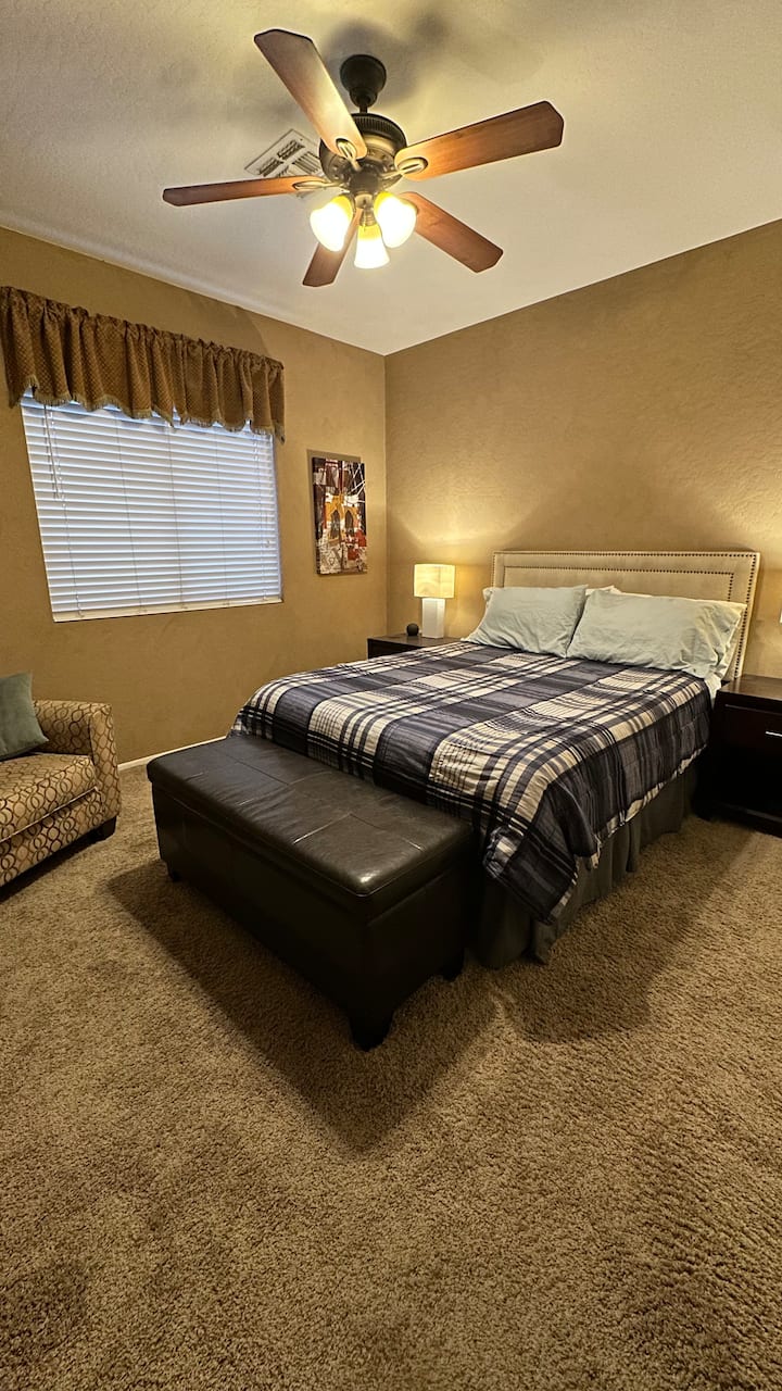 Bedroom #3 - main floor (no stairs).  Queen bed, sitting chair, Smart TV.