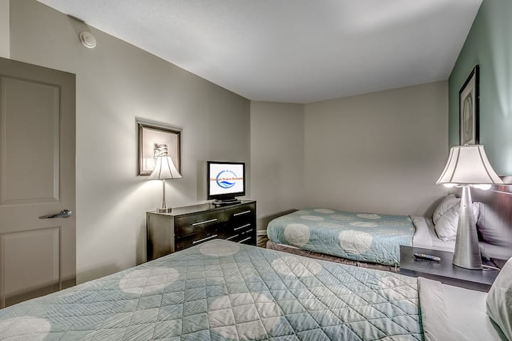 Second Bedroom Featuring Two Comfortable Beds and TV