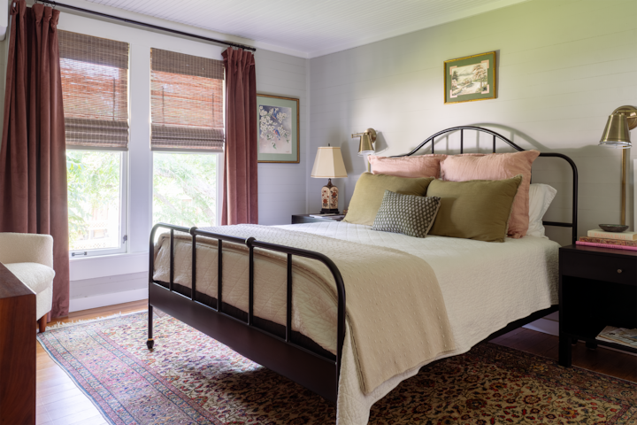 The second guest bedroom located on upper floor is filled with warm shades of pink, original photographs and a flat screen tv, is perfectly situated across the hall from its own private full bath.