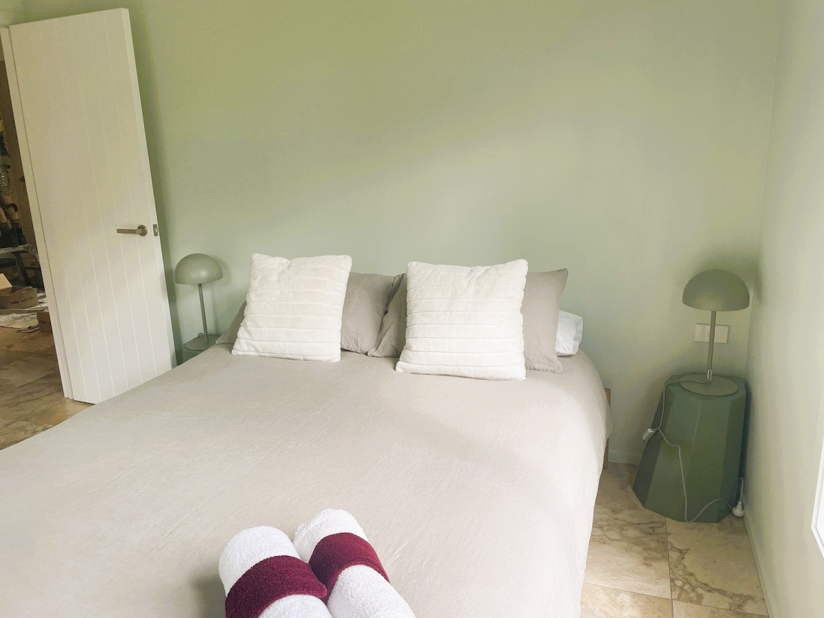 Beautifully relaxing space for 2 in this restful mint green bedroom. French doors opening onto the deck. 