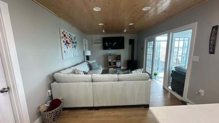 Enjoy the lake view through the sunroom from the living room.