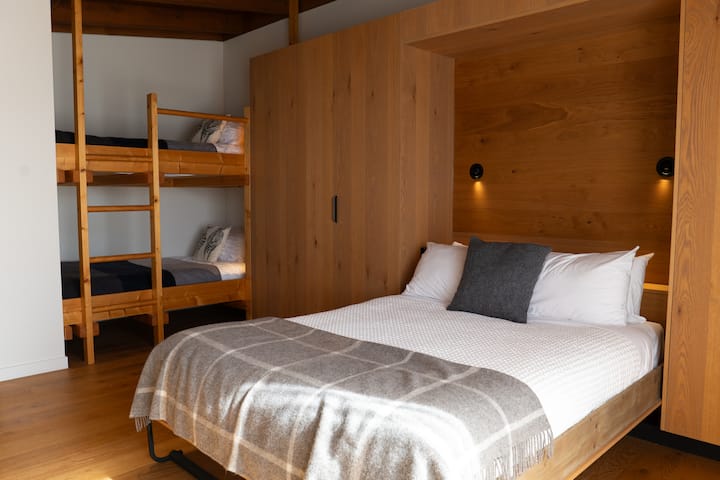 This is our guest suite, separated from the main house with its own entrance. Built to the same impeccable Passiv Haus standard as the main house, the suite is luxurious accommodation sleeping four via a Queen Size bed and a set of built in bunks.