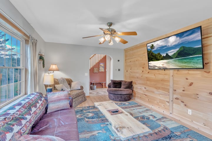 Living room with plenty of seating and smart TV and an electric fireplace!