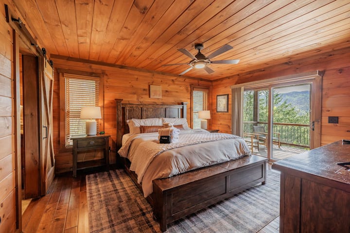 Restful primary bedroom at Above the Clouds — a cozy North Georgia mountain cabin rental near Blue Ridge with rustic decor and peaceful mountain surroundings.