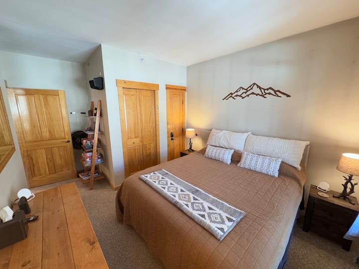 King size bed in a large master bedroom.