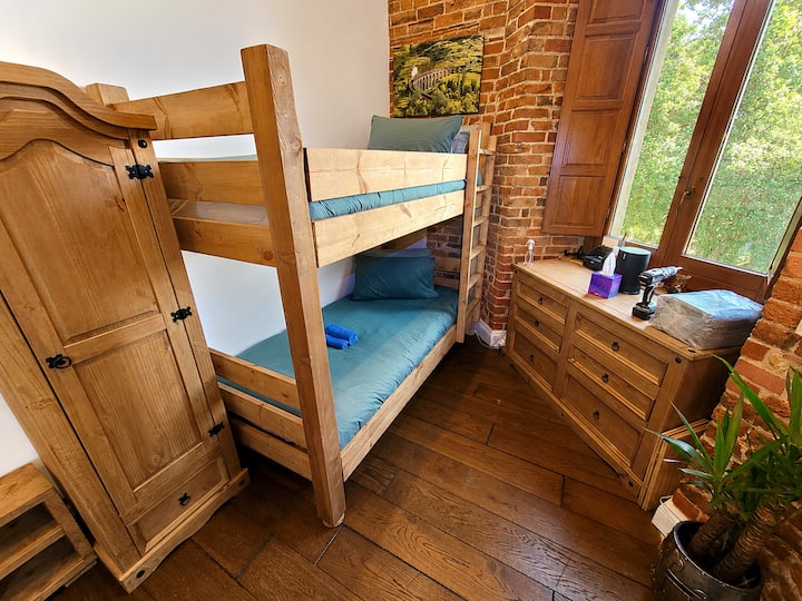 A compact second bedroom with bespoke built-in bunk beds, ideal for children, close friends or extra guests.