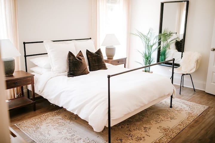 Style and comfort meet: the main floor bedroom offers a queen bed and full-length mirror, while featuring a Purple mattress and Organic Supima Cotton Linens in all bedrooms for a luxurious stay.