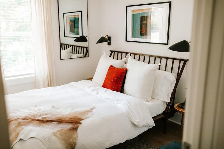 Cozy comfort awaits: this second-level bedroom features a queen bed, inviting you to unwind and relax in style.