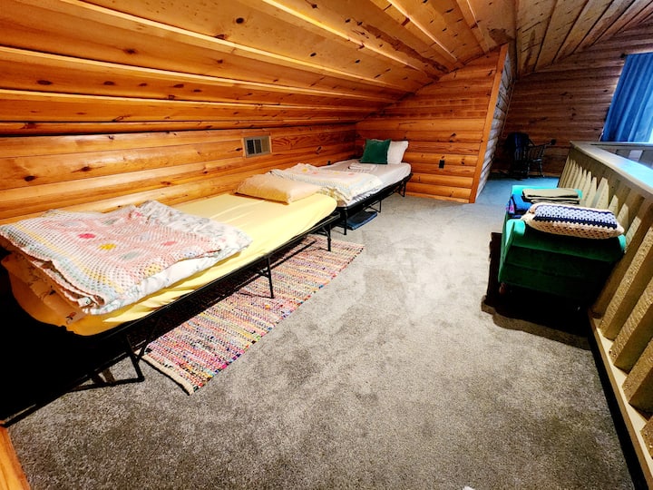 The loft area above the living room provides 2 plush twin beds
