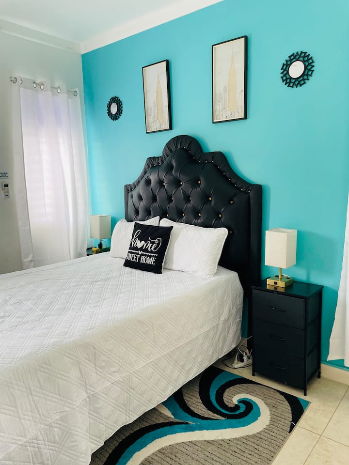 Queen bedroom. This spacious bedroom provides a peaceful retreat with AC and TV for relaxation 