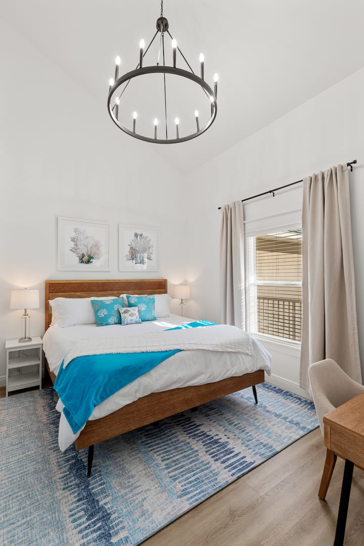 Modern Coastal Master Bedroom with King size bed, black-out curtains, and en suite bath.