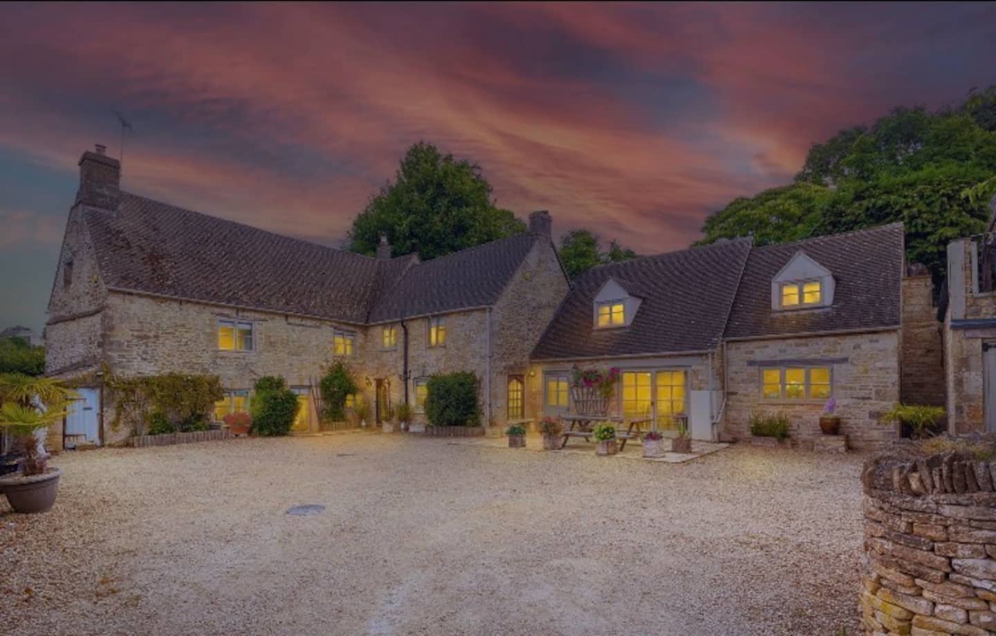 Honey-stone Cotswold manor house at golden hour