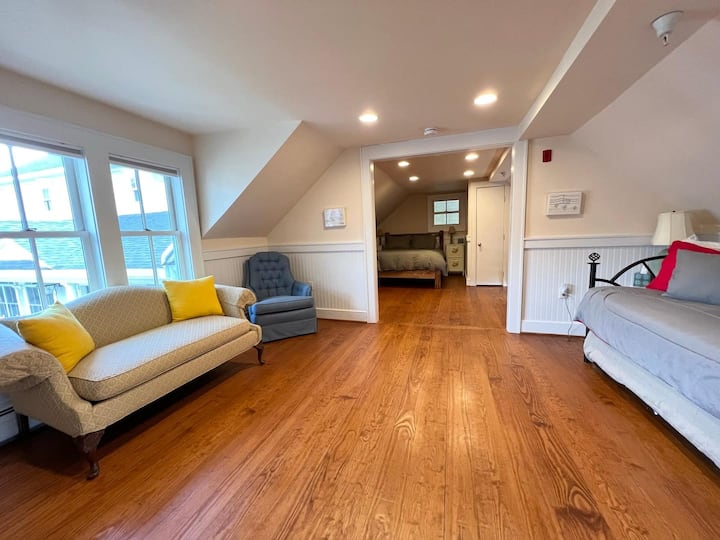 Bedroom in farmhouse w/queen bed, 2 singles, and a bathroom.