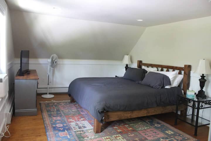 Bedroom in farmhouse w/king bed and bathroom.
