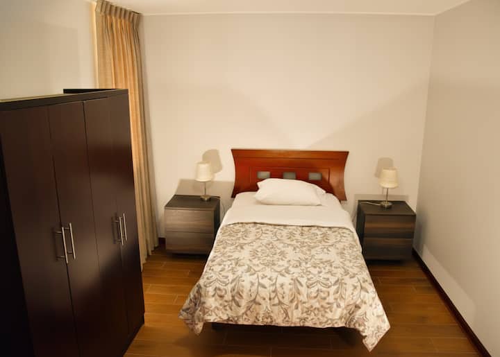 Queen size bed - Bed linen - Pillows - Towel - Space to store clothes - Hooks to hang clothes.