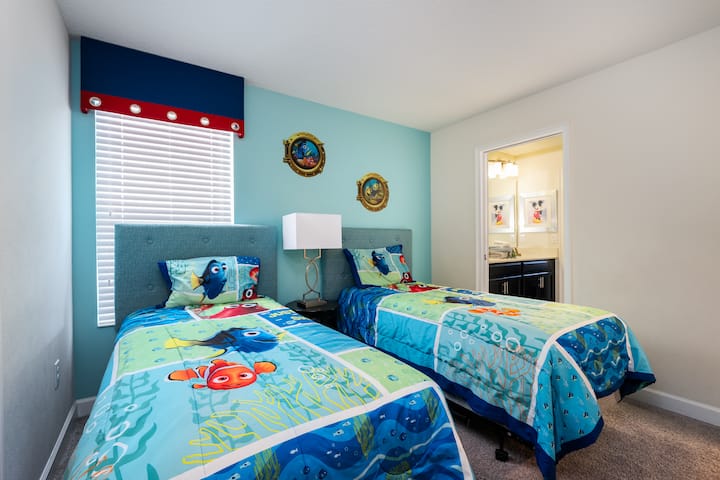 Fun-themed children's bedroom featuring twin beds with colorful decor, perfect for little ones and fans of animated movies.