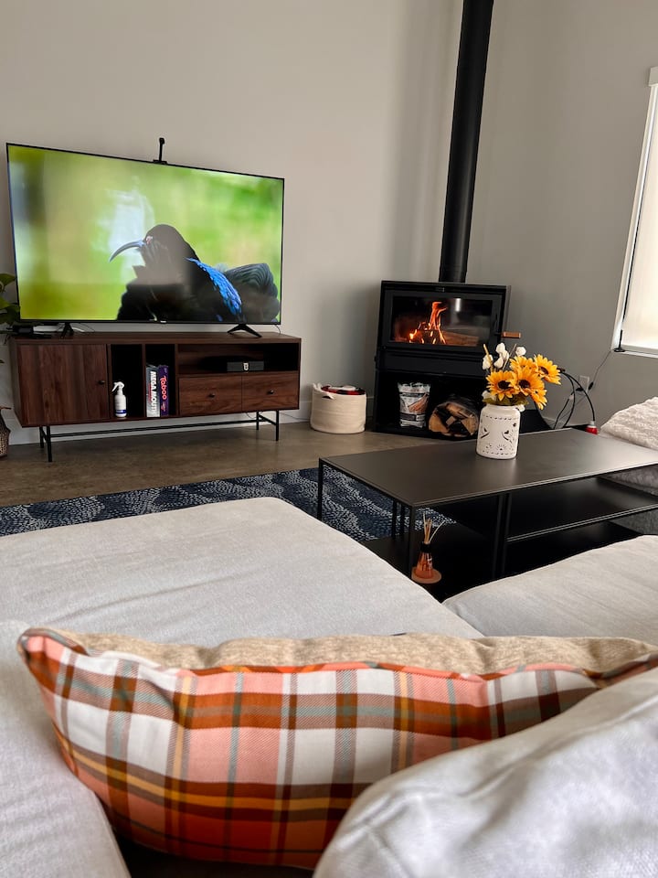 Enjoy our wood burning stove, watch a movie on our 60 inch TV or play some games, all from the comfort of our well cushioned couch.