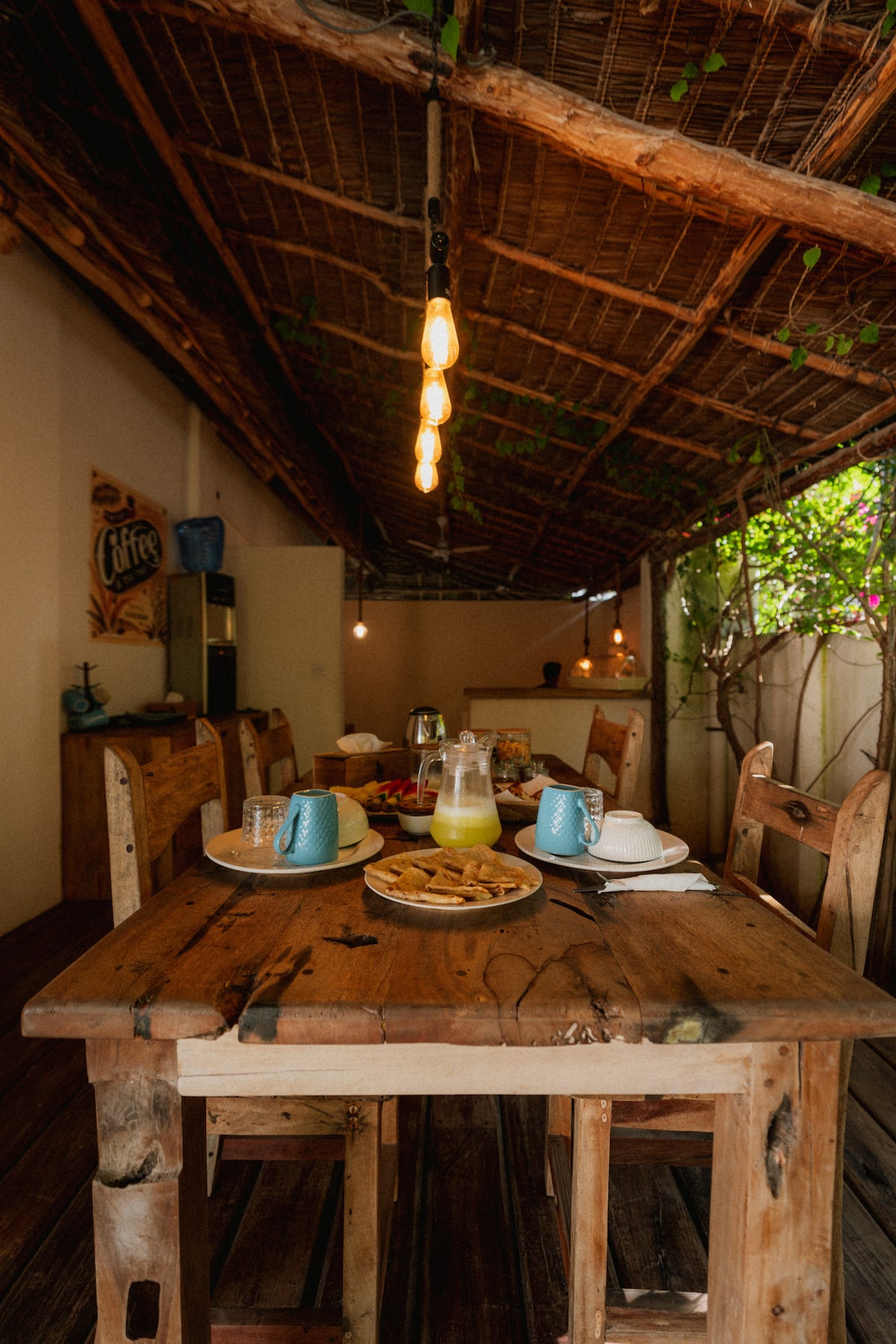 Open-air dining area under the makuti roof