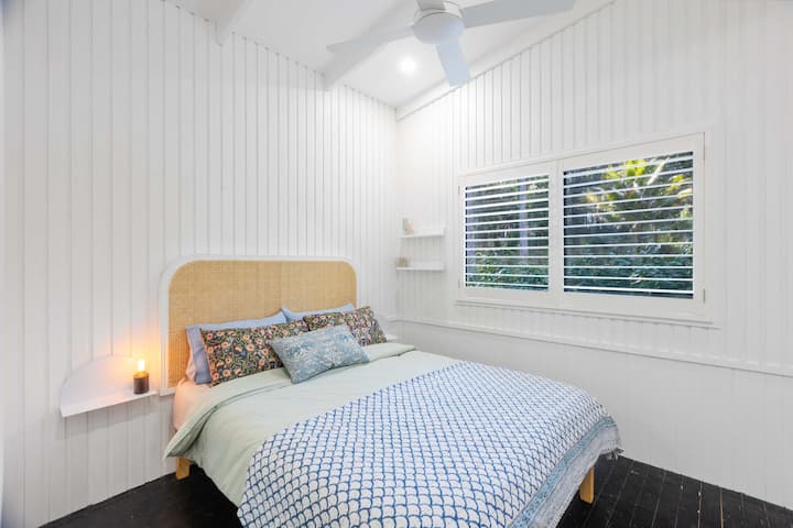 Bright and airy queen room with built in storage