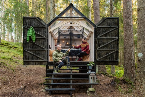 Glasshouse glamping in peaceful forest by a lake