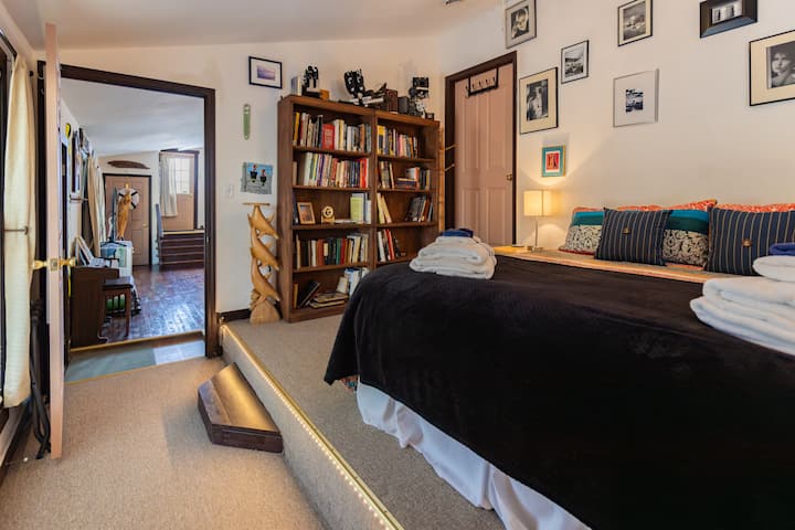 Bedroom with a King mattress and bookcase