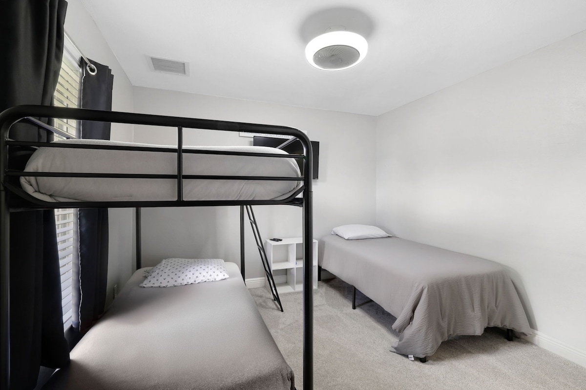 Family-friendly room with bunk beds, twin bed, and TV for relaxing nights.