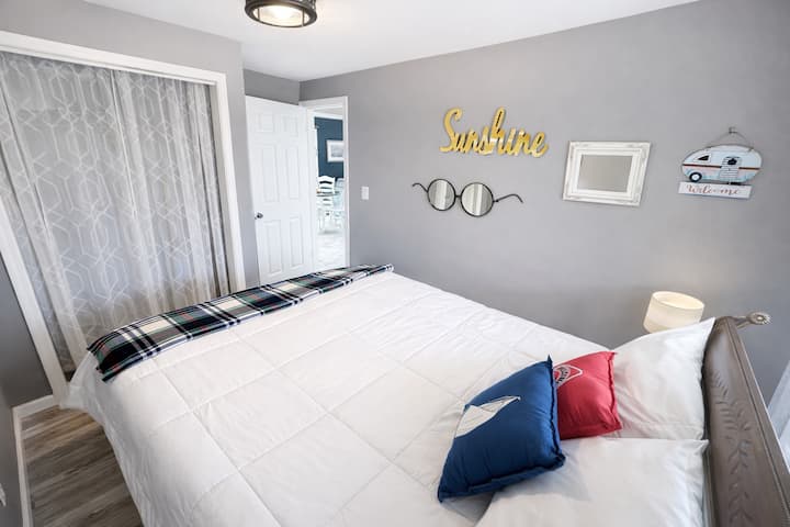 Queen bed, nightstands, and reading lamps, fan and closet for storage. 