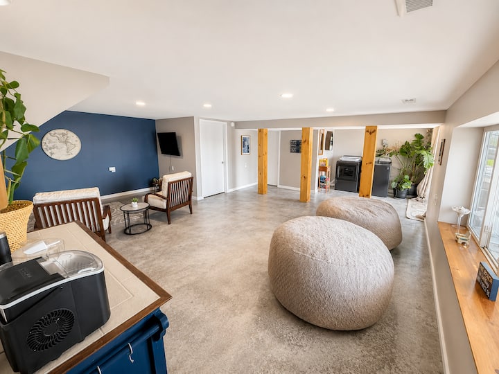 55” inch Roku smart tv you can plug into. Comfy accent chairs, a single person futon, large bag chairs, washer and dryer as well as bathroom #2 & a walk out patio. 