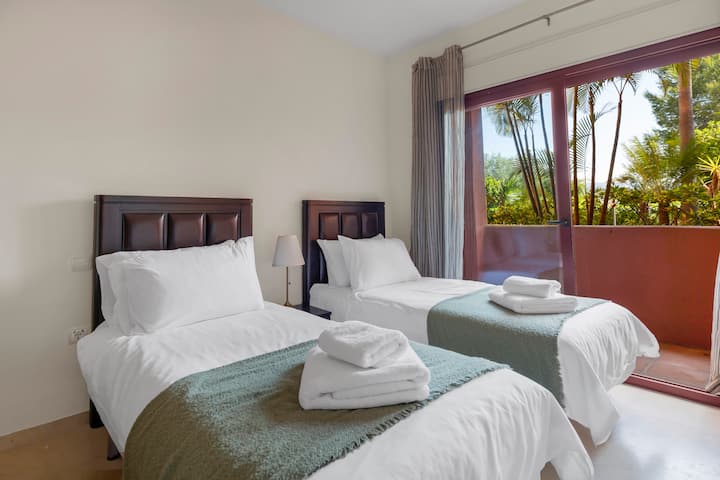 Comfortable bedroom featuring twin beds, designed to provide a relaxing and versatile space suitable for friends, family, or children.