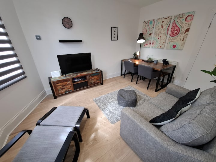 Sofa bed, arm chair with a soft bounce, footstool , large dining table, smart TV.
