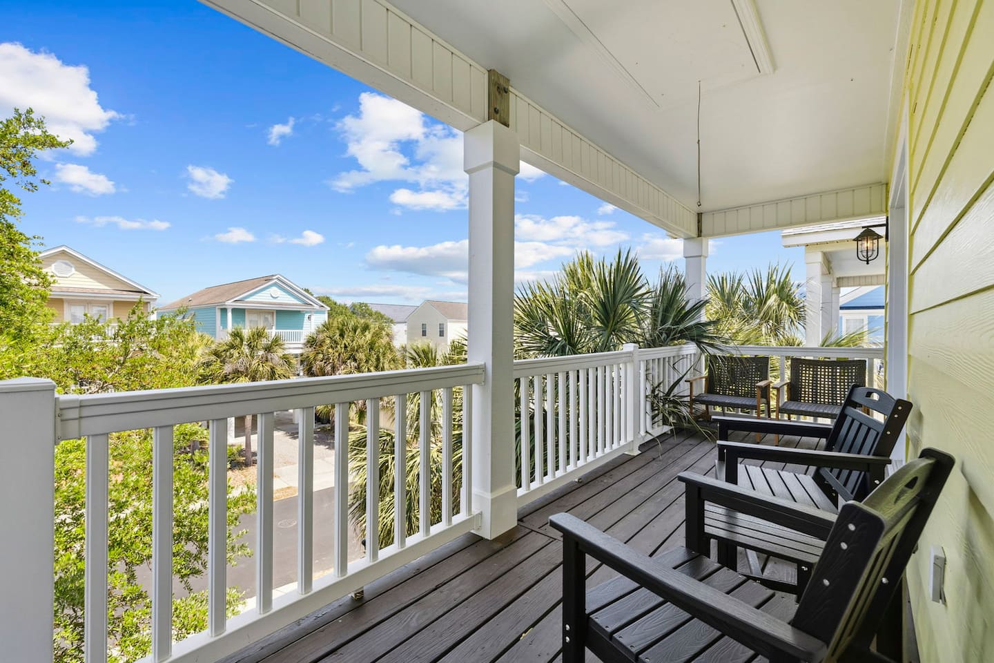 Start the morning here on the covered porch, with comfortable seating and a palm tree filling the view while the coffee cools down.