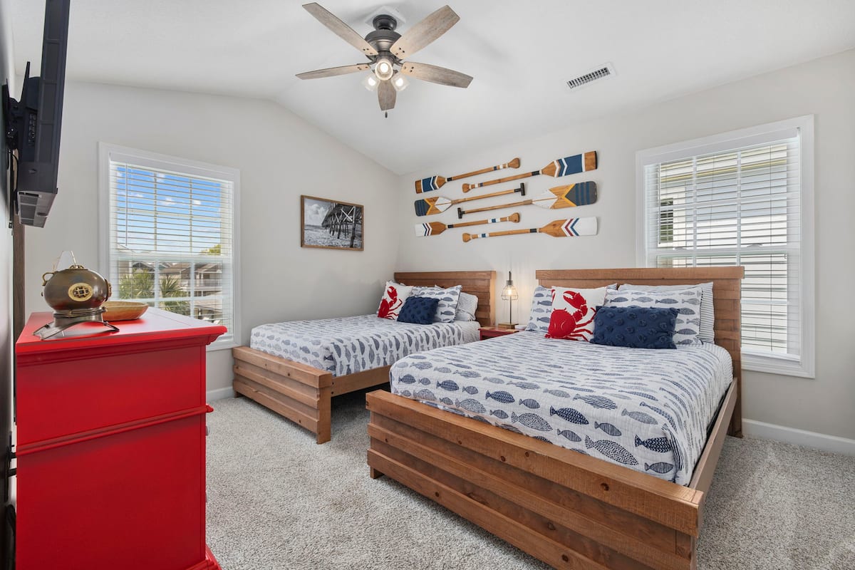 Settle into the nautical double room: two double beds, fish-print bedding, oar decor on the wall, your own TV, and a private en-suite bathroom.