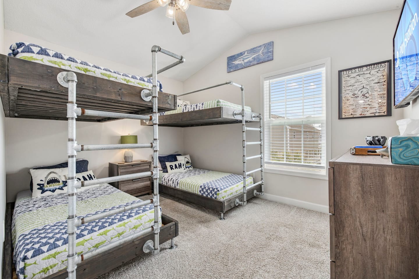 Send the kids to the shark bunk room: two industrial pipe-frame bunks, shark-themed bedding and wall art, and a PS4 upstairs to keep them busy.