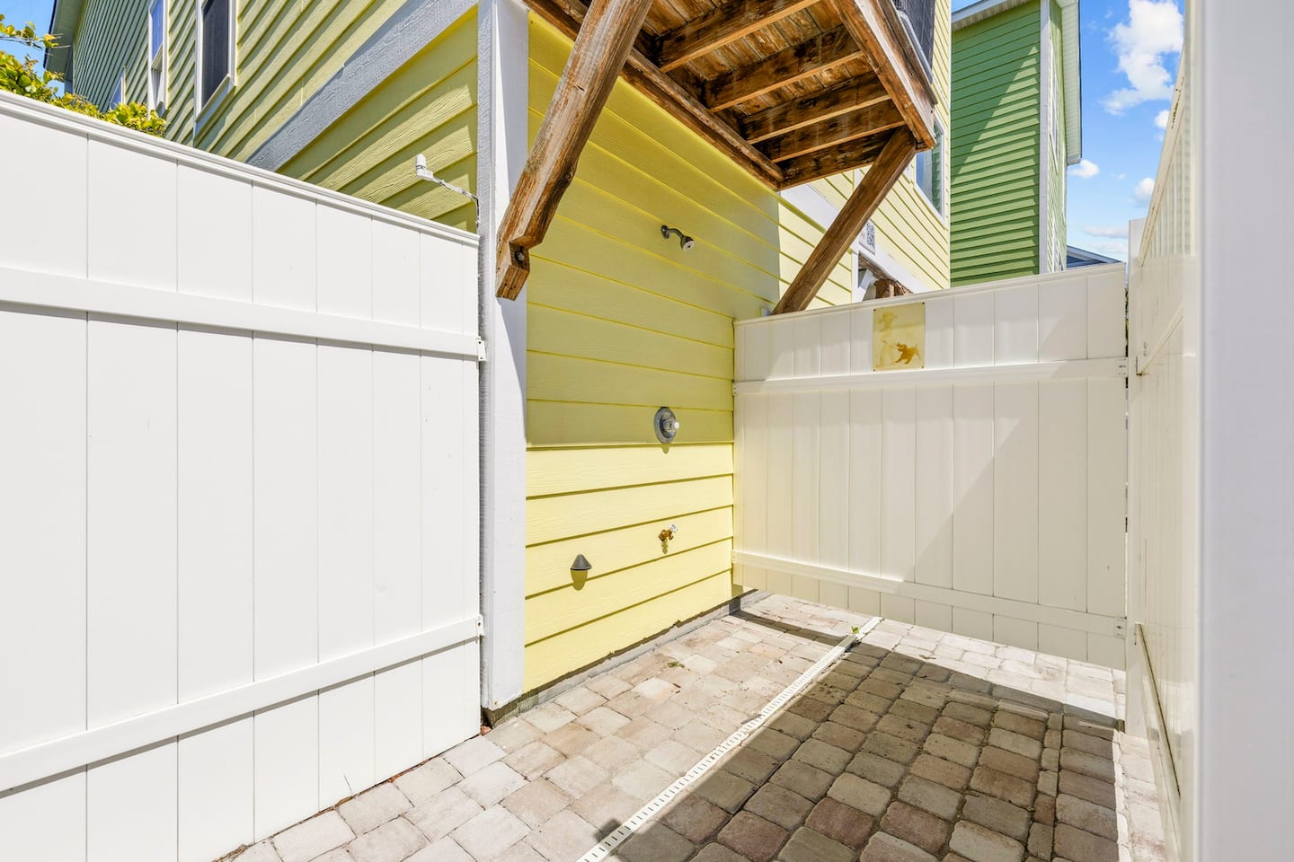 Rinse the sand off before you track it inside. The enclosed outdoor shower is tucked into the pool area.