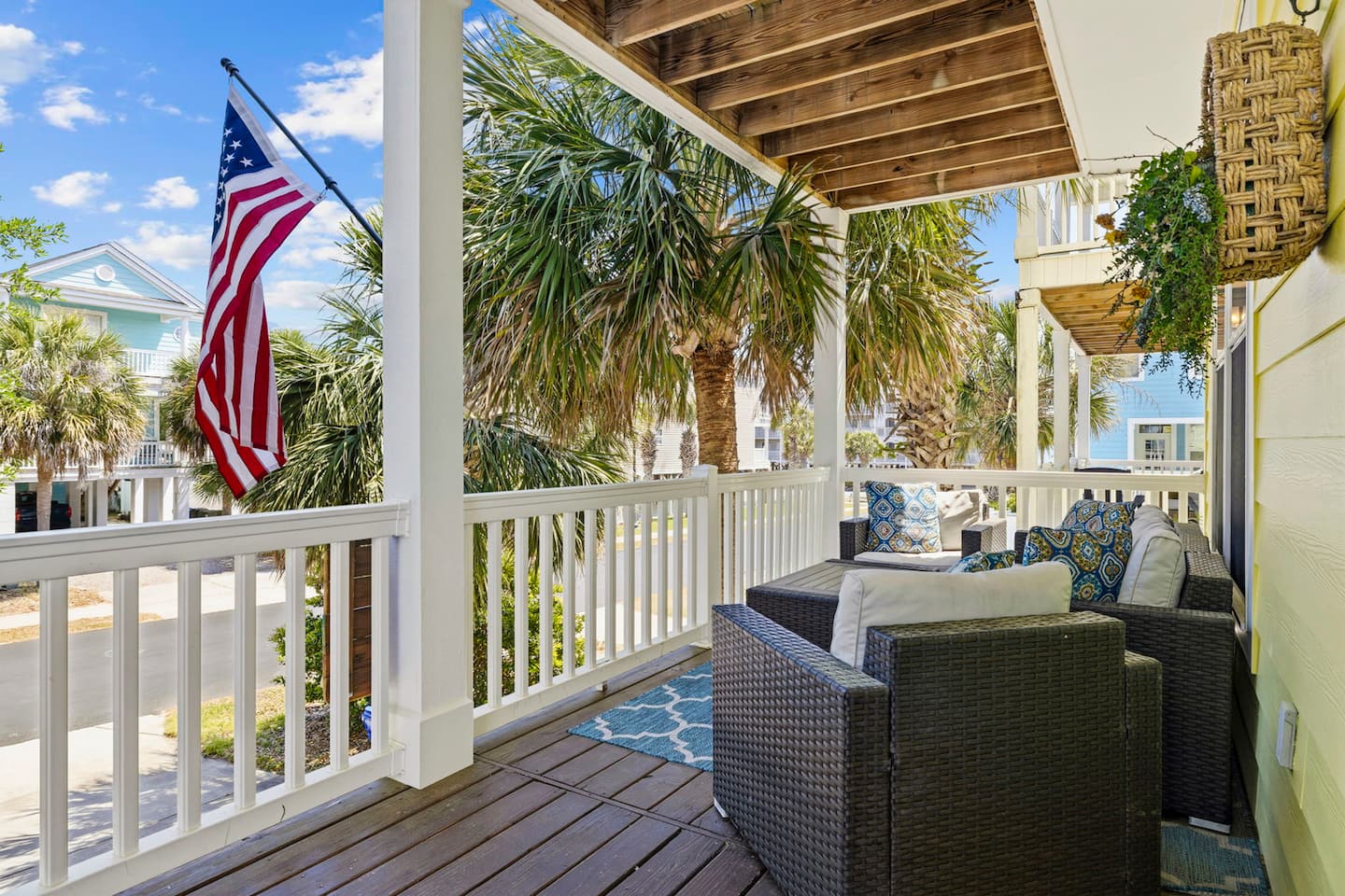 Settle into the front porch with wicker sofa and cushions. American flag flying, palms swaying, and nobody asking you to be anywhere.