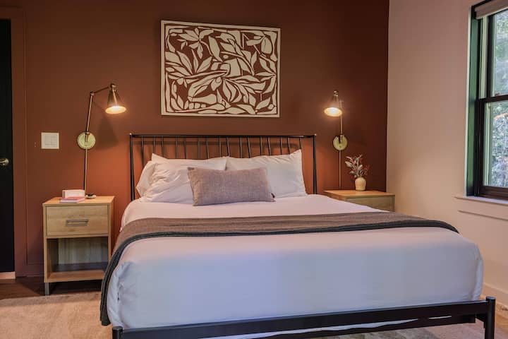Earthy tones, Pottery Barn quality, and a private porch with a hammock waiting outside. River Run's warm brownie bedroom is a quiet favorite for a reason.