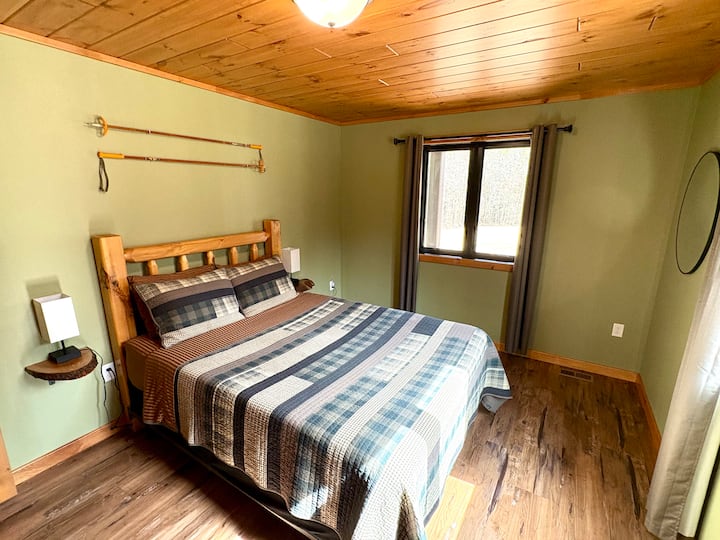 Main level bedroom with queen bed.