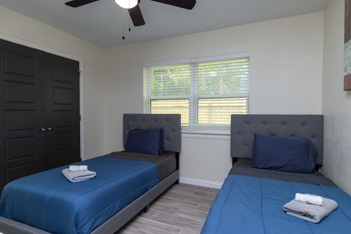 Versatile third bedroom featuring two comfortable twin beds, ideal for kids or groups of friends.