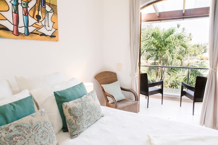 Bedroom 2 with queen bed. Balcony overlooking pool and beach