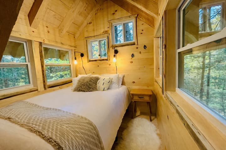 Watch the snow fall, rain drift through the trees, or leaves dance outside your windows from this cozy treetop bedroom retreat.
