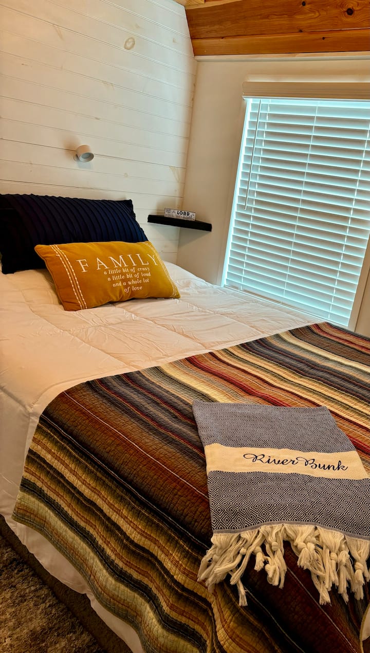 Queen size bed with extra blankets and pillows. 