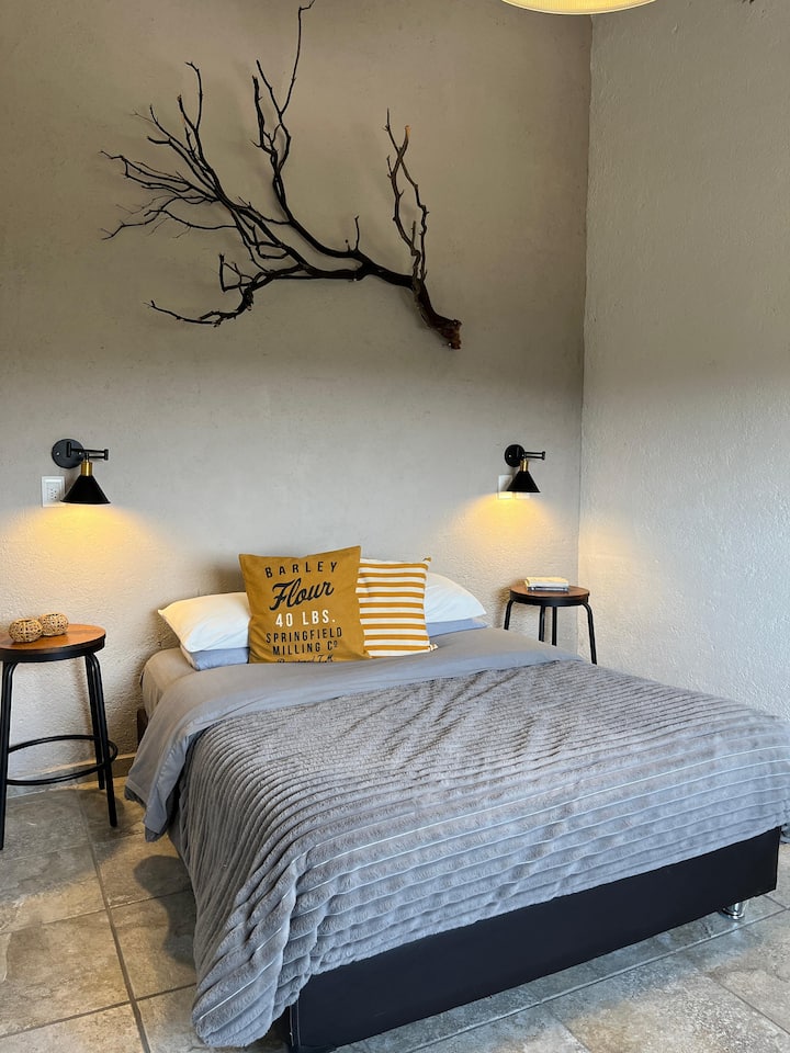 غرفة نوم مع سرير كوين وسرير أريكة لشخصين. 