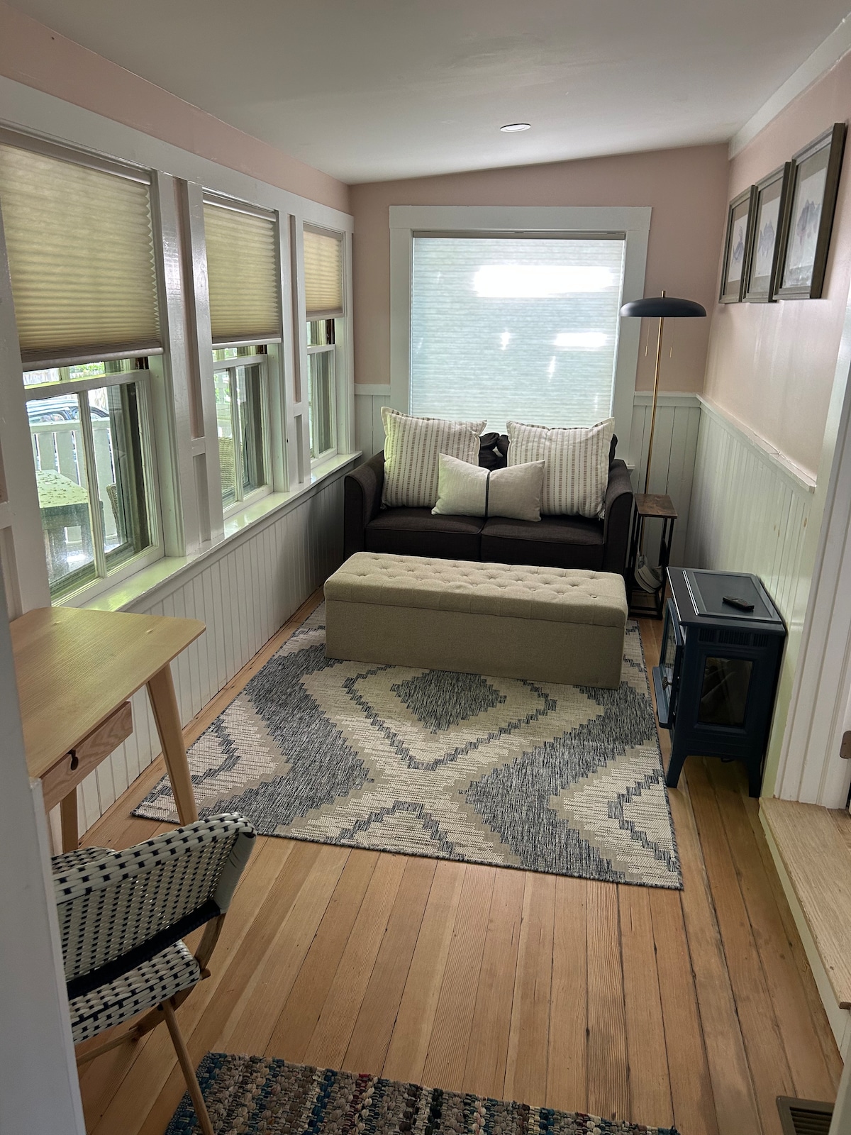 Sunroom/office with desk, pull out couch with comfy twin mattress, electric fireplace, blackout shades and privacy curtain. 